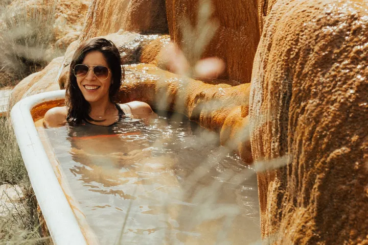 woman soaking in bathtub at Mystic Hot Springs