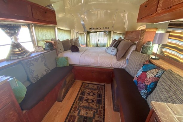 a living room filled with furniture and a large window