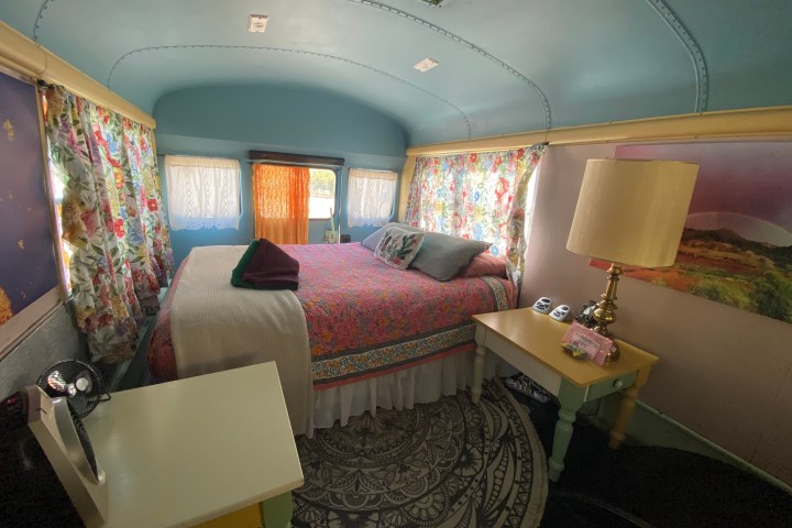 a bedroom with a bed and desk in a room