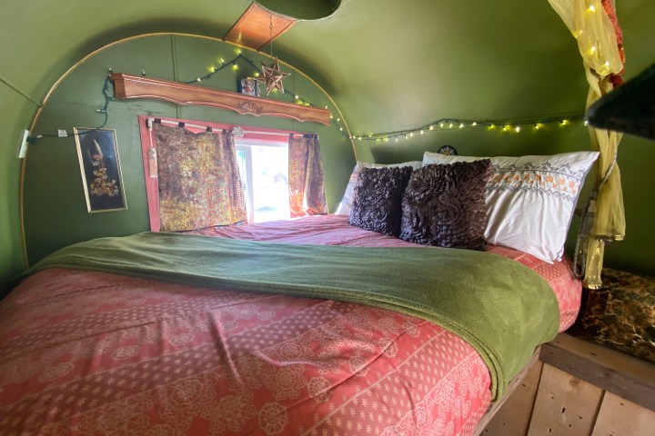 a bedroom with a bed and a chair in a room